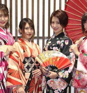 four women in kimonos are holding umbrellas