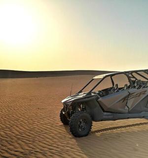 a gray jeep parked in the desert