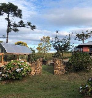 a house with a stone wall and a building