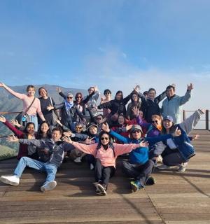 a group of people posing for a picture on a bridge
