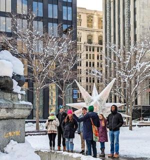 a group of people standing around a statue in the snow