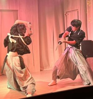 two children dancing on a stage in a performance