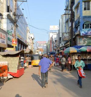 a group of people walking down a street in a city