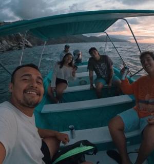 a group of people sitting on a boat in the water