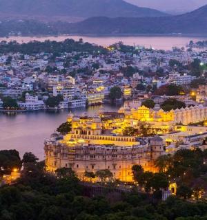 a night view of a large building on a river
