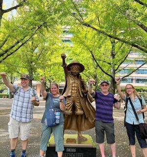a group of people standing in front of a statue