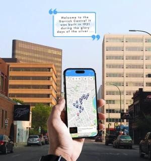 a person holding up a cell phone with a map