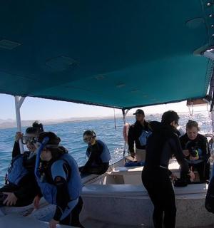 a group of people on a boat in the water