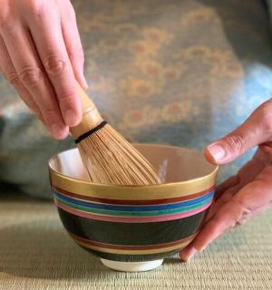 a person holding a wooden brush in a bowl
