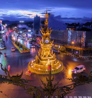 a city with a clock tower in the middle of a street