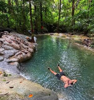 a man laying in the water in a river