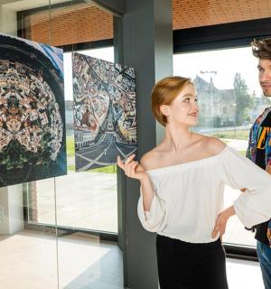 a man and a woman standing in front of some art