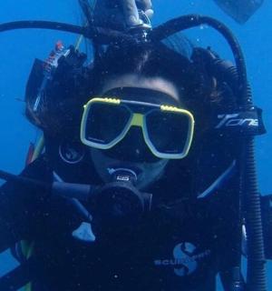 a woman in a diving suit and sunglasses