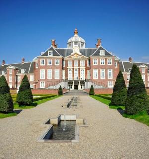 a large building with a fountain in front of it