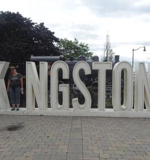 a person standing in front of a large sign