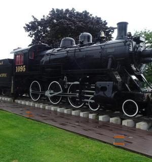 a black train on display in a park