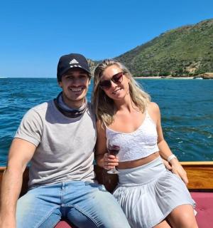 a man and a woman sitting on a boat