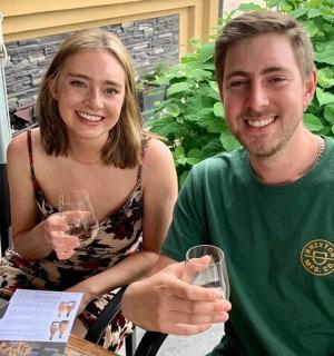 一男一女坐在桌边,手捧酒杯