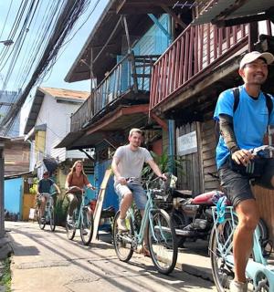 a group of people riding bikes down a street
