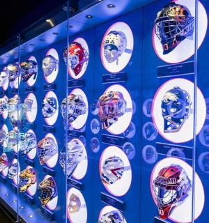 a wall of helmets on display in a room