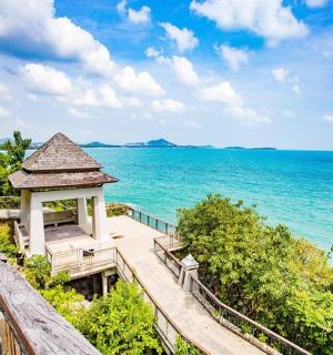 a gazebo on a boardwalk next to the ocean