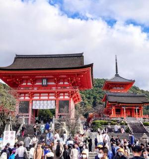 a crowd of people walking in front of a building