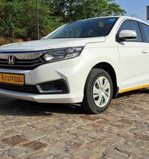 a white car is parked on a brick road