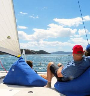 a group of people sitting on inflatables on a boat
