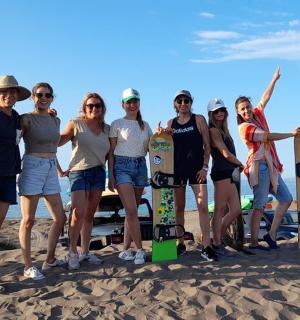 a group of people posing for a picture on the beach