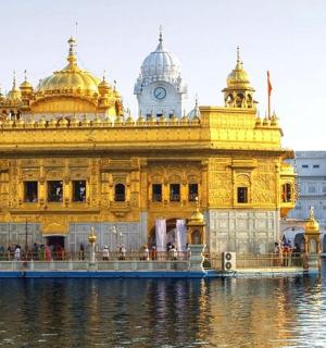a woman standing in front of a golden temple