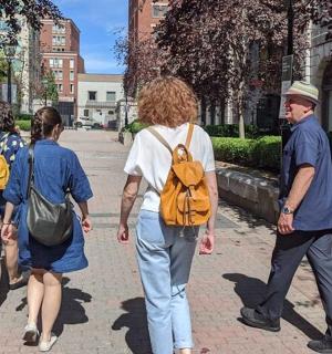 a group of people walking down a sidewalk