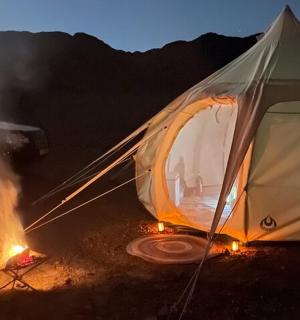 a tent with a fire in front of it