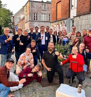 a group of people posing for a picture with drinks