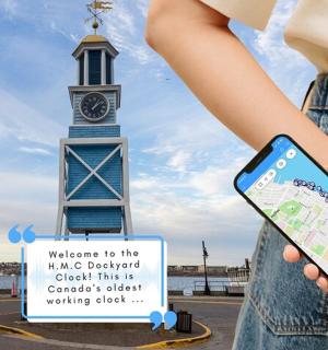 a woman holding a cell phone in front of a clock tower