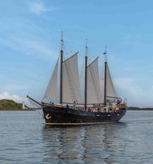 a large boat with sails in the water
