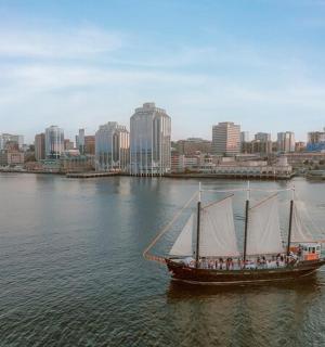 a boat in the water with a city in the background