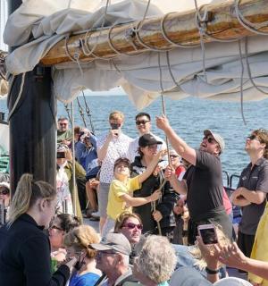 a crowd of people standing on a boat