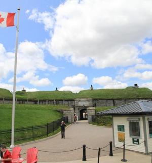 a canadian flag flying in front of a building