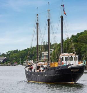 a large black boat floating in the water