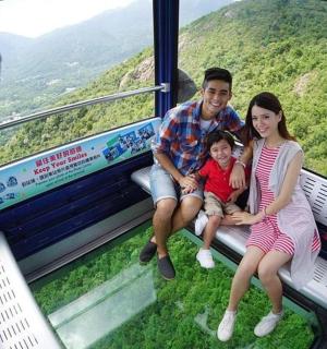 a man and a woman and a child sitting on a train