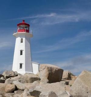 a lighthouse sitting on top of some rocks