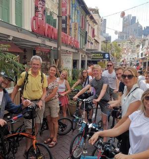 a group of people standing on a street with bikes