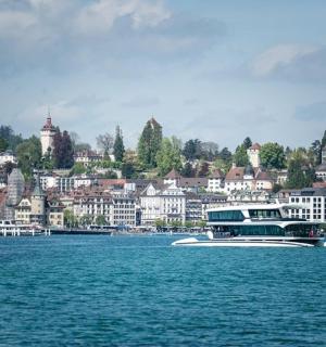 a boat in the water in front of a city