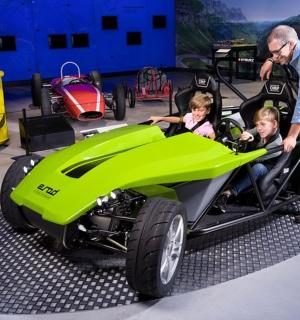 a man and two children in a green car