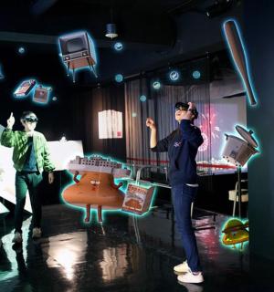 two people standing on a stage in a room