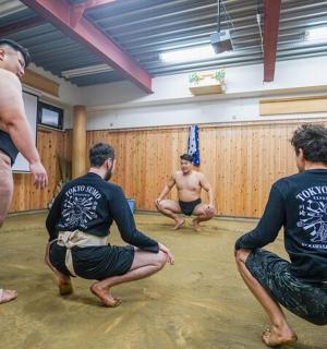 a group of men sitting in a yoga class