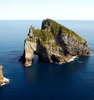 a large rock formation in the ocean
