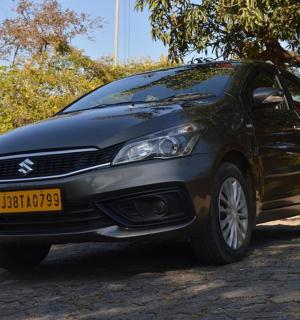 a black car parked on a dirt road