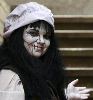 a woman dressed up in a costume with her face painted