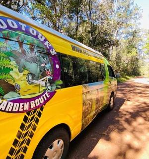 a yellow van is parked on a dirt road